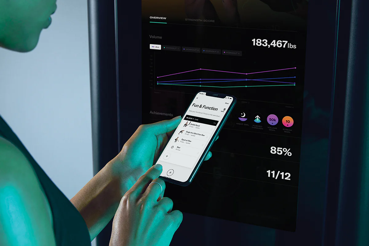 Tonal app screen showing a member building a custom workout on their phone