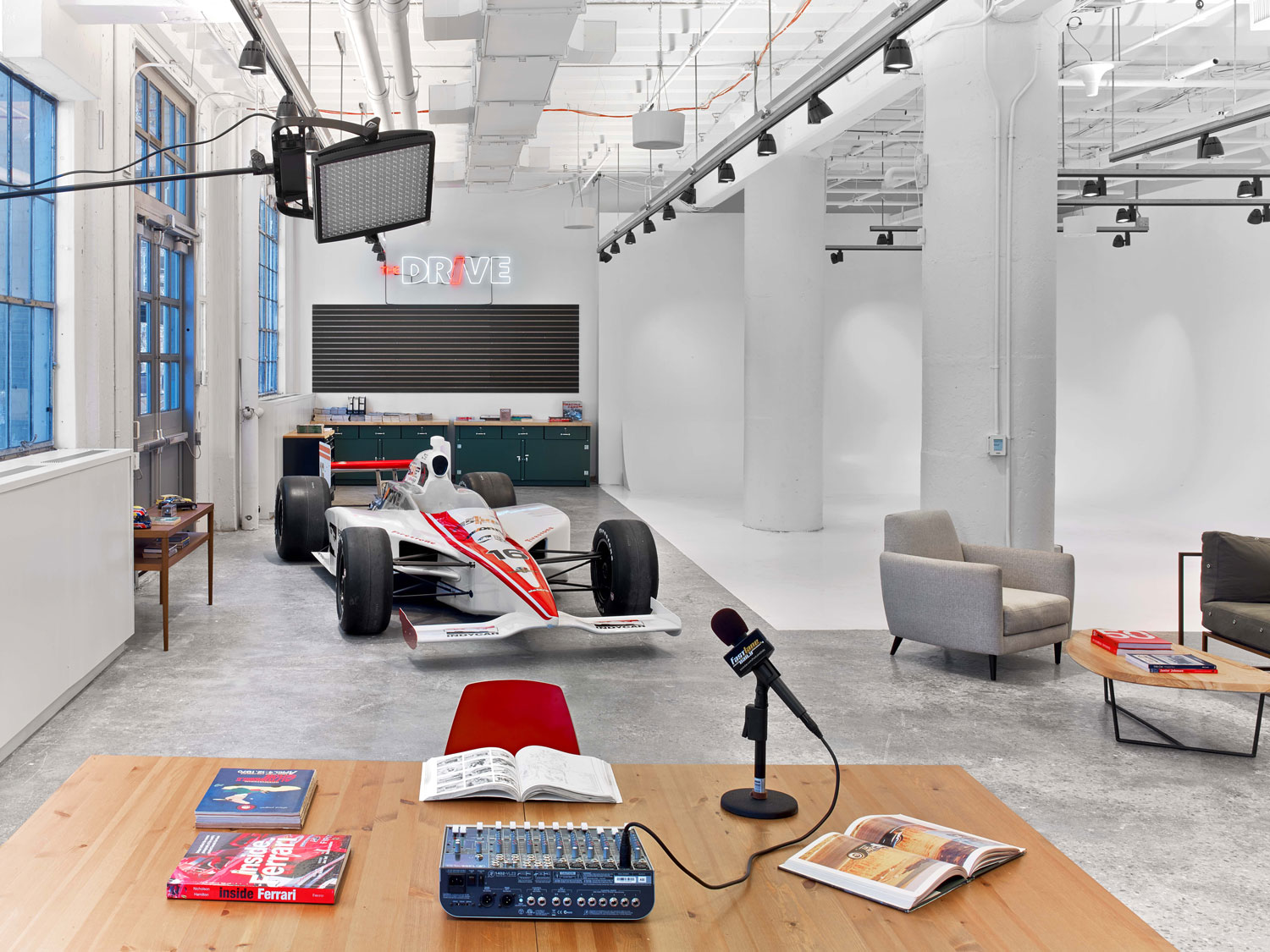 The Drive showroom at Time Inc.'s Foundry, featuring a race car and neon sign