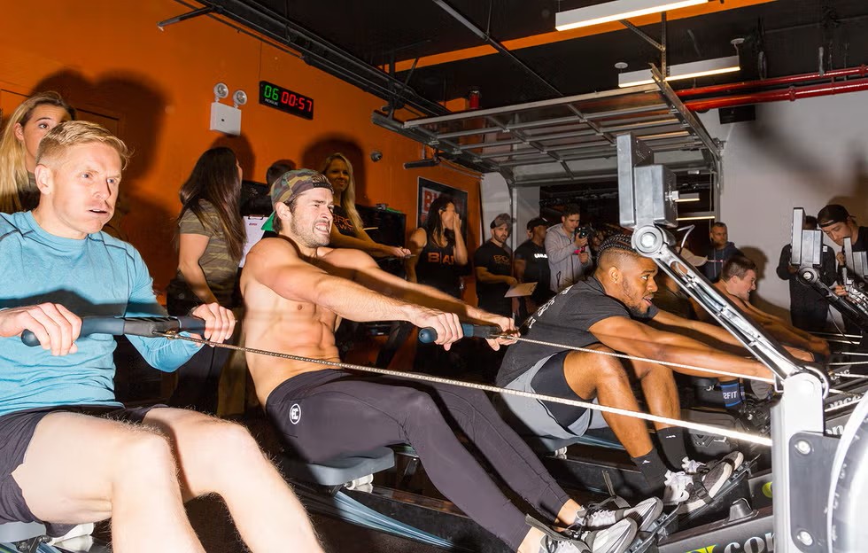 Competitors rowing during the Men's Health Open fitness competition